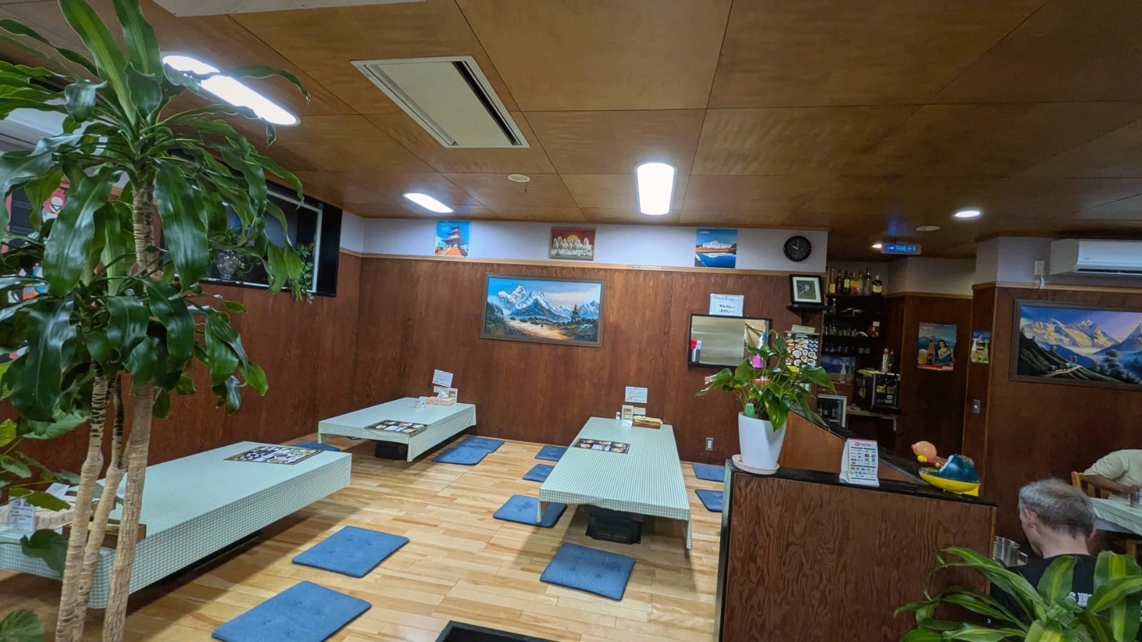 The tatami room inside Aaha, beneath Himalayan paintings